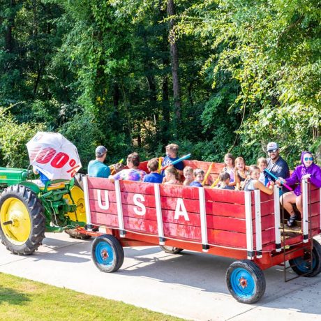 several riders in a large wagon