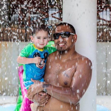 man and child under giant mushroom fountain
